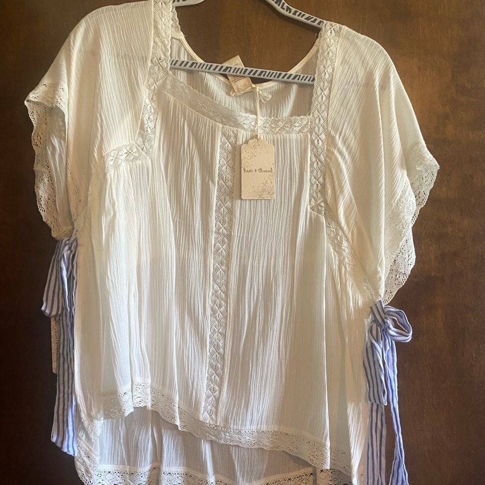 White with navy bows on sleeves.